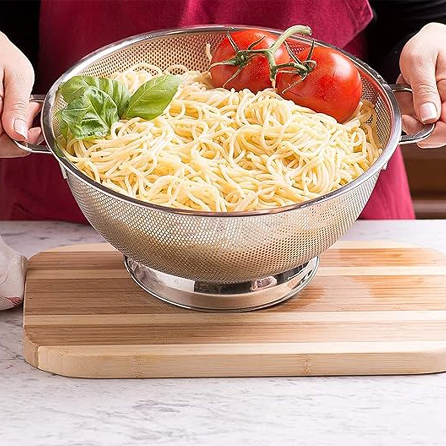 Wukusy Apex stainless steel mesh colander for draining pasta, vegetables, and fruits in the kitchen.