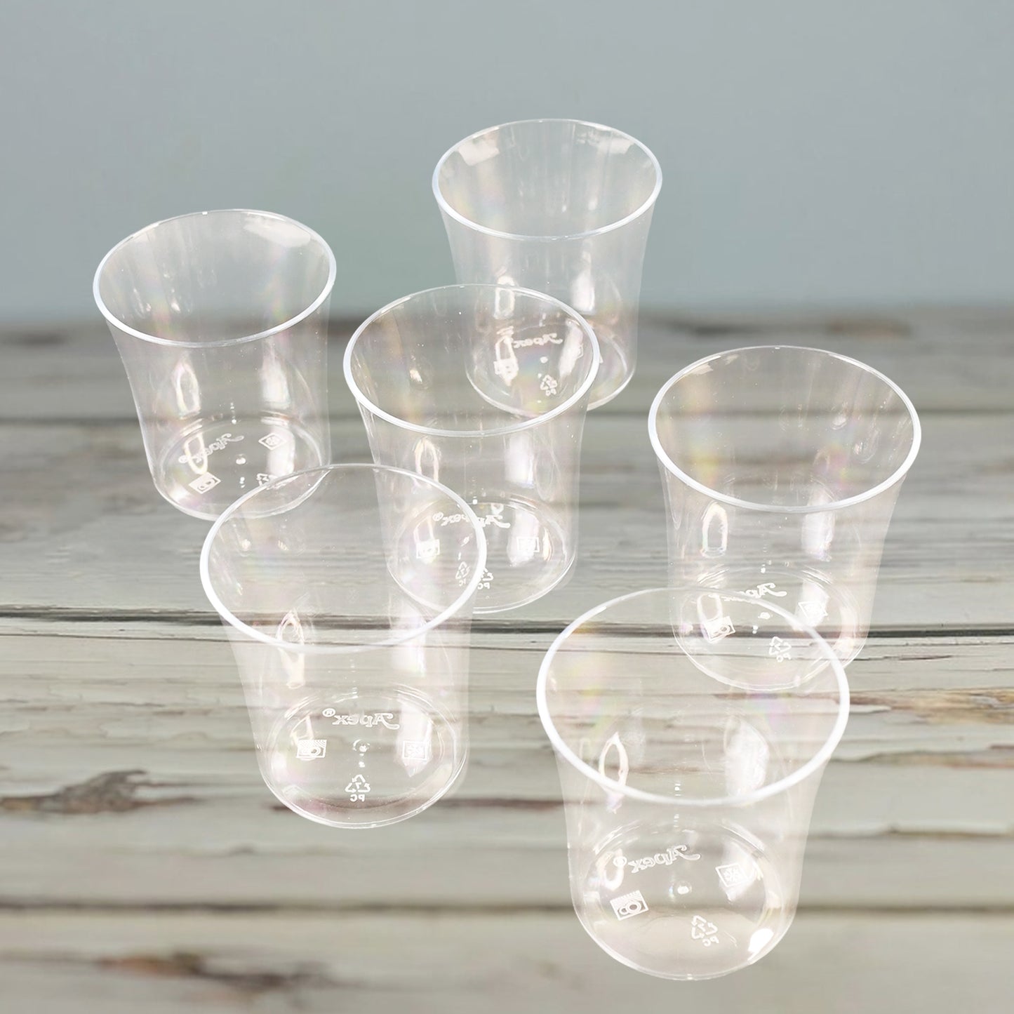 Six clear plastic glasses from Wukusy Apex Welcome set, suitable for daily use, displayed on a kitchen countertop.