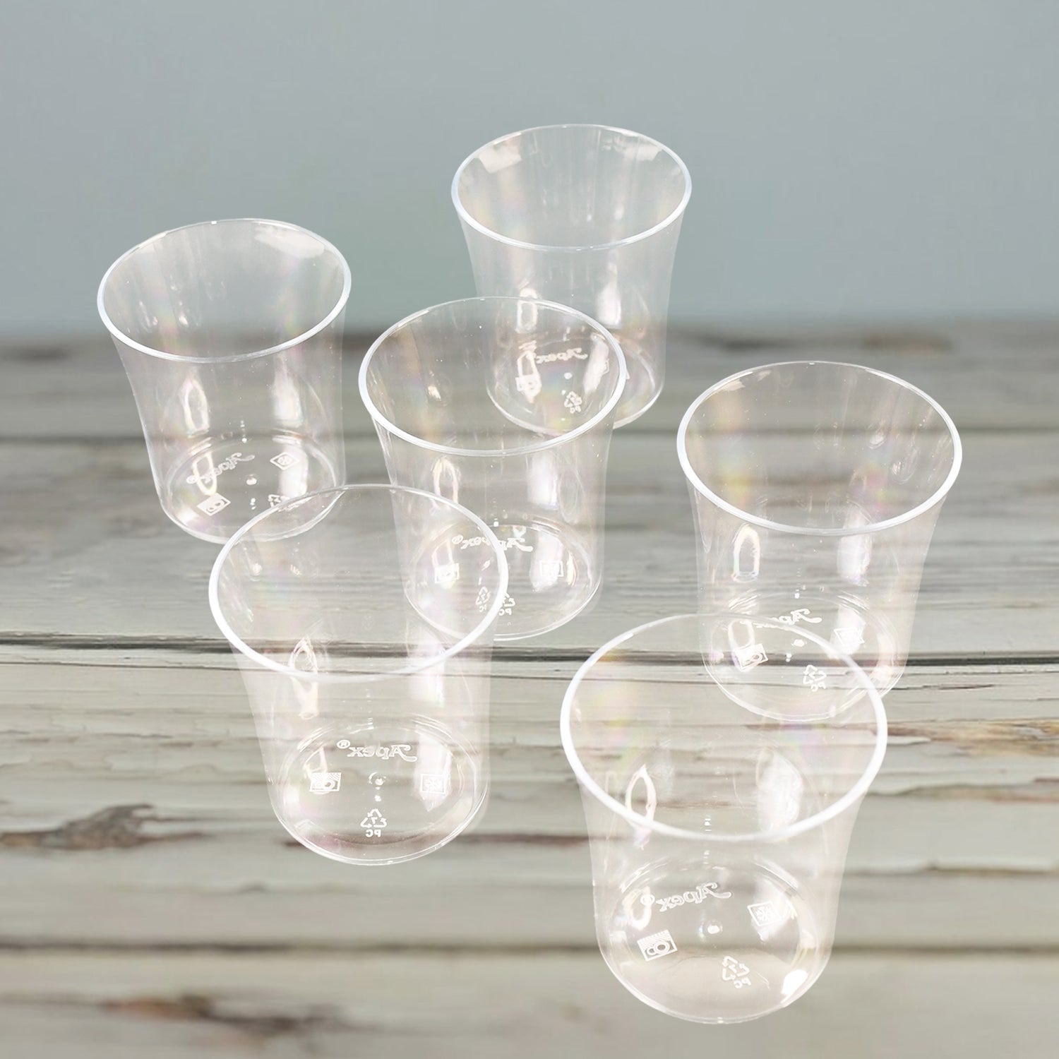 Six clear plastic glasses from Wukusy Apex Welcome set, suitable for daily use, displayed on a kitchen countertop.