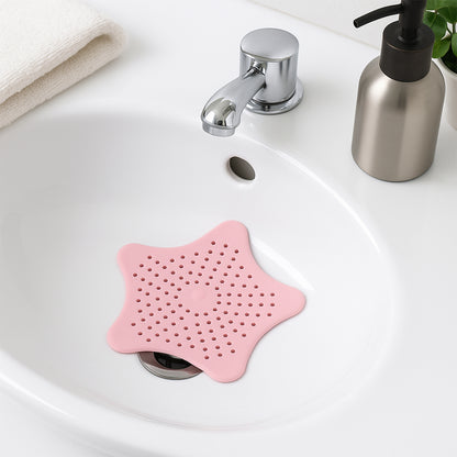 Baby pink silicone star-shaped sink filter by Wukusy, bathroom hair catcher and drain strainer for basin.