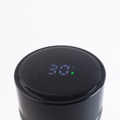 Black vacuum insulated water bottle by Wukusy, 500ml, stainless steel, with a sleek design for hot and cold beverages.