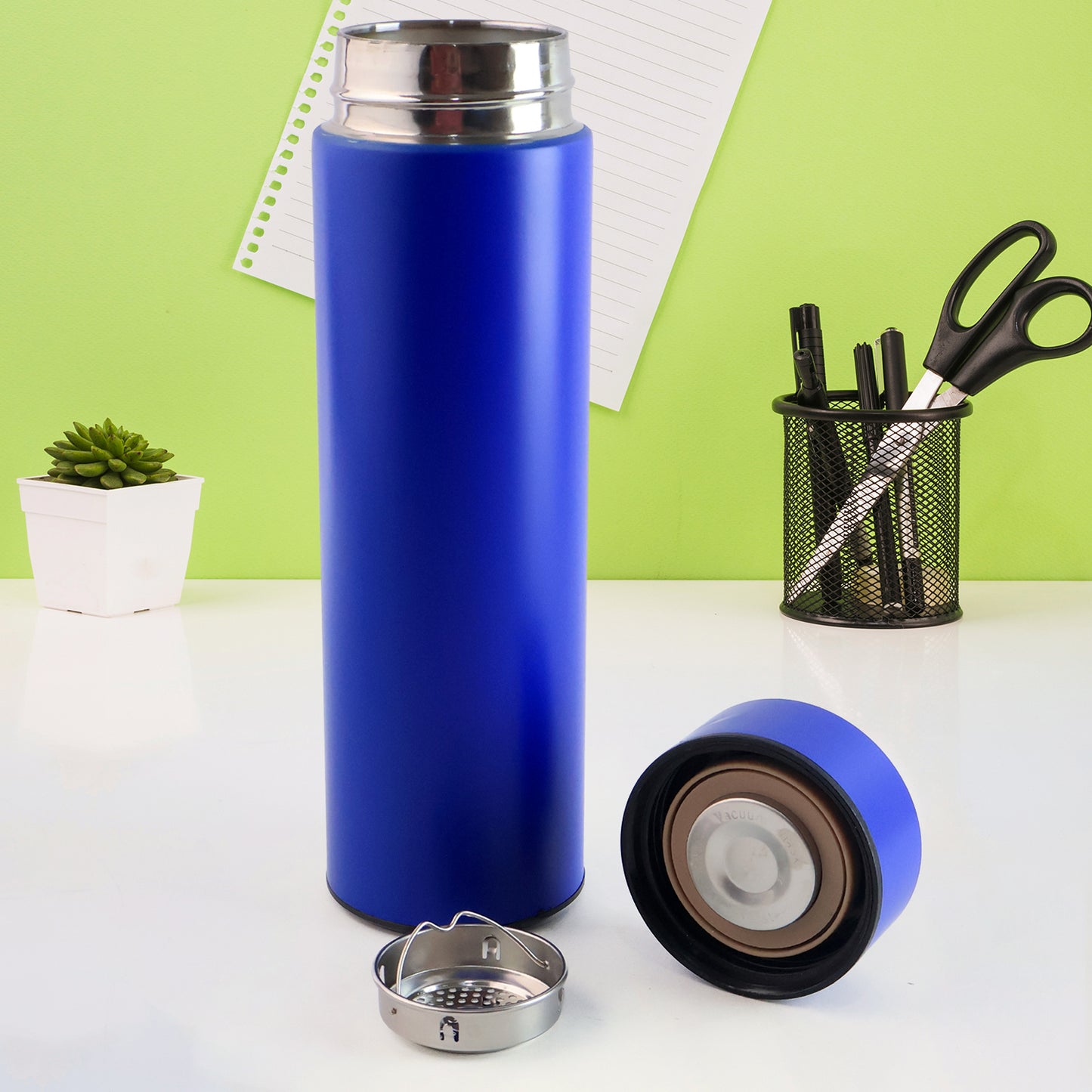 Blue Wukusy vacuum insulated water bottle, 500ml, for hot and cold beverages, in a sleek home and kitchen setting.