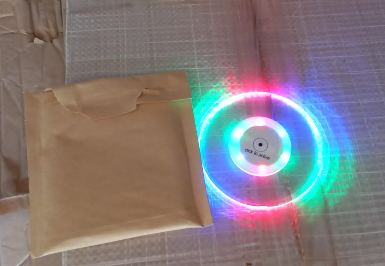 Colorful LED cocktail coaster by Wukusy, round and ultra-thin, glowing with vibrant lights, perfect for home bar or party use.