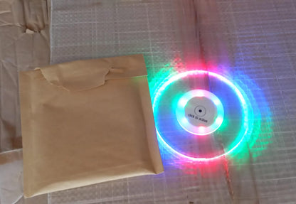 Colorful LED cocktail coaster by Wukusy, round and ultra-thin, glowing with vibrant lights, perfect for home bar or party use.