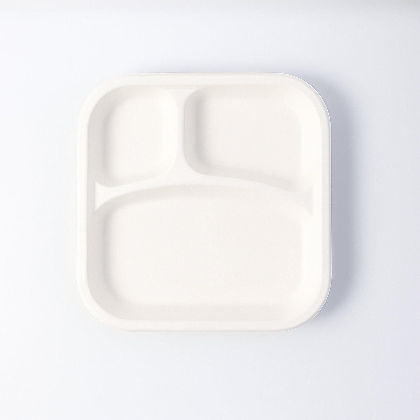 Wukusy compostable bagasse 3-compartment square meal plate for home and kitchen use, showing divided sections for food.