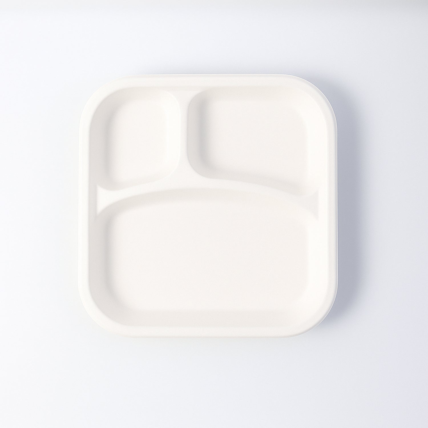 Wukusy compostable bagasse 3-compartment square meal plate for home and kitchen use, showing divided sections for food.