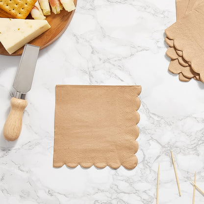 Set of 120 Wukusy disposable tissue napkins with scalloped edge, ideal for home and kitchen use, shown stacked in the image.