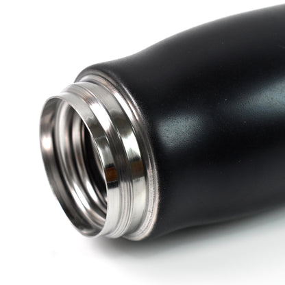 Wukusy double wall vacuum insulated water bottle, 550 ml, in stainless steel with a black screw-top lid, on a kitchen countertop.