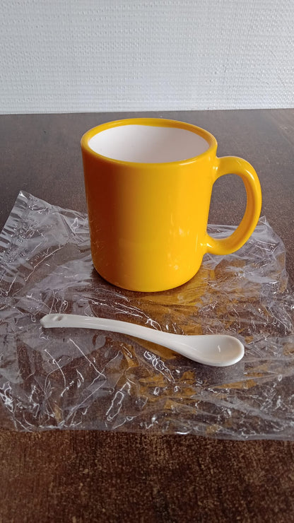 Elegant ceramic mug with matching spoon by Wukusy, featuring a smooth finish and stylish design for home and kitchen use.
