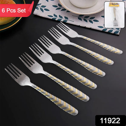 Six elegant stainless steel forks from Wukusy arranged on a kitchen table, showcasing shiny, durable cutlery for dining use.