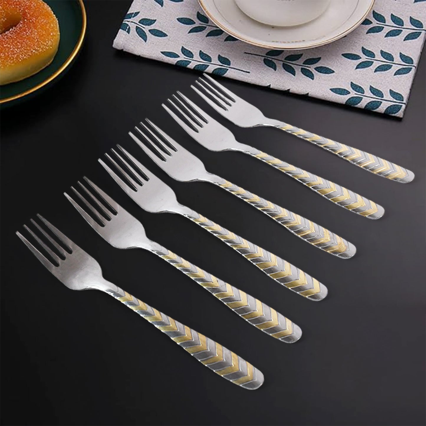 Six elegant stainless steel forks from Wukusy, arranged on a kitchen table, showcasing their polished finish and classic design.