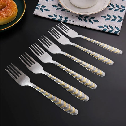 Six elegant stainless steel forks from Wukusy, arranged on a kitchen table, showcasing their polished finish and classic design.