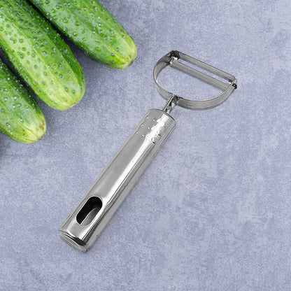 Wukusy fruit and vegetable peeler tool for easy peel removal, shown on a kitchen countertop with peeled fruit and vegetables.