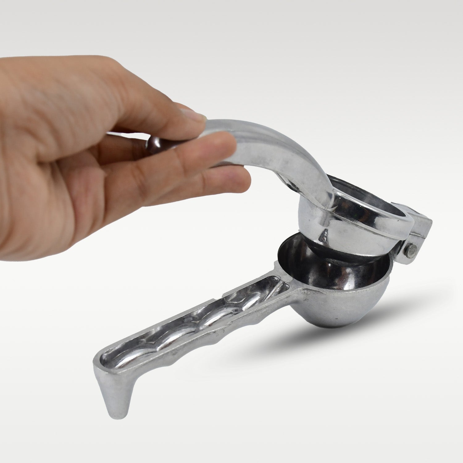 Wukusy steel lemon squeezer in a home and kitchen setting, showcasing its durable stainless steel design for citrus juice extraction.
