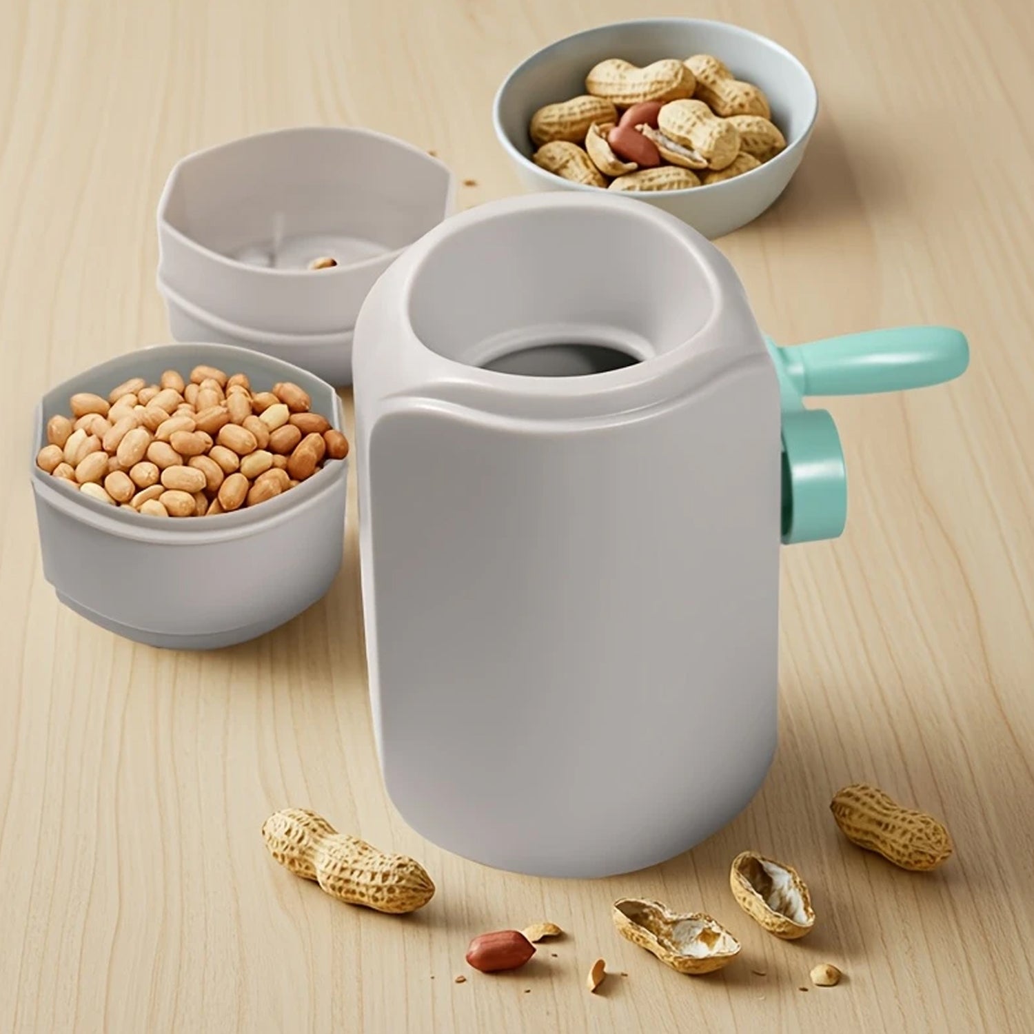 Wukusy manual hand-crank peanut sheller machine for home and kitchen use, with a sturdy metal body and ergonomic handle.