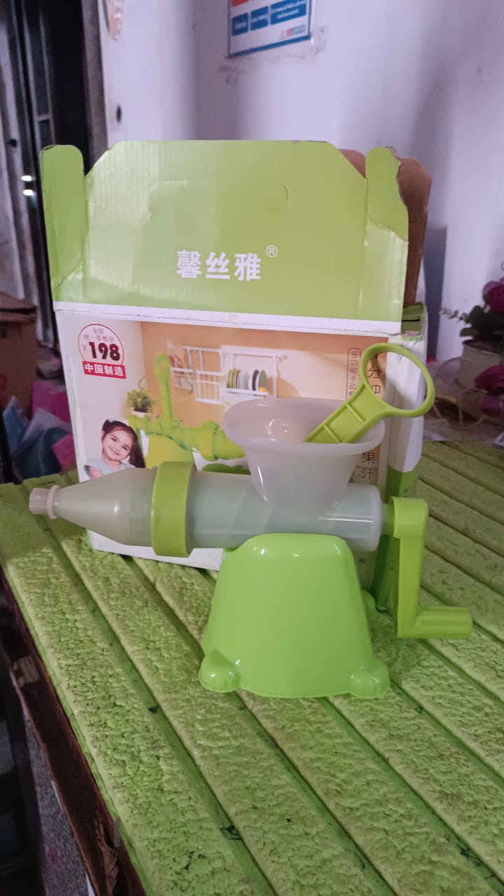Wukusy manual plastic fruit and vegetable juicer for home use with a clear handle and bowl not included in the image.