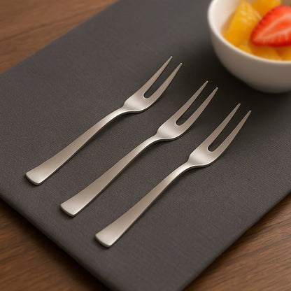 Set of three Wukusy mini dessert fruit forks for serving small fruits and desserts, stainless steel with ergonomic handles.