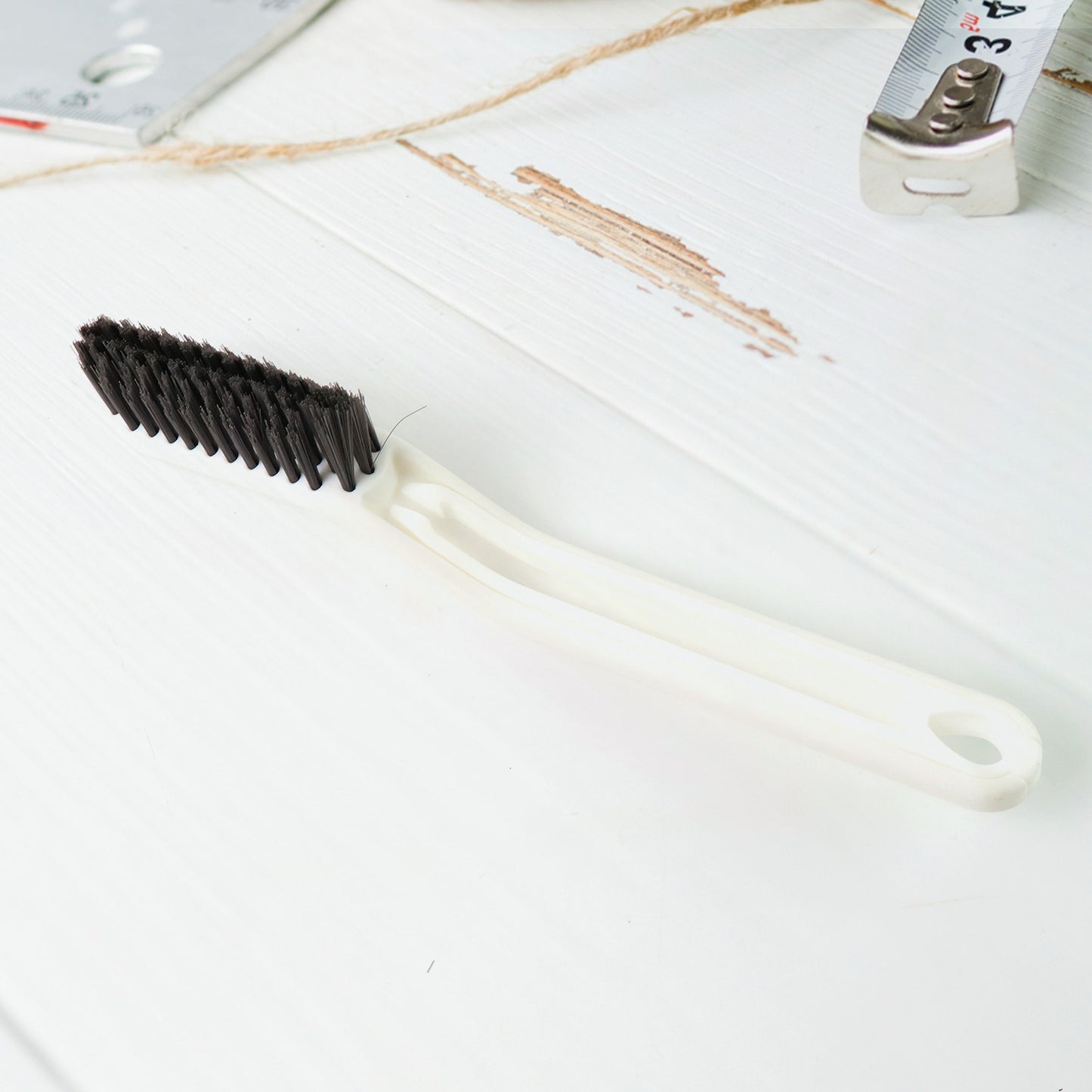 Wukusy 2-in-1 multifunctional floor gap cleaning brush for home and kitchen, designed for easy dirt removal from tight spaces.