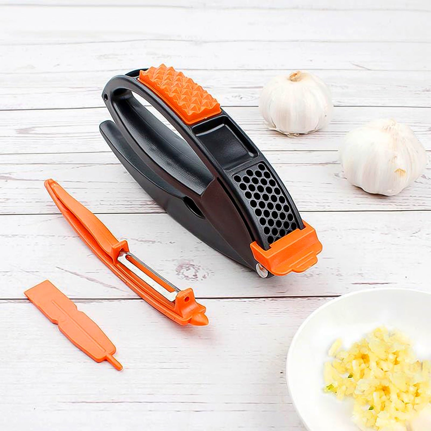 Wukusy multifunctional garlic press and mincing tool for crushing garlic easily in home and kitchen use.