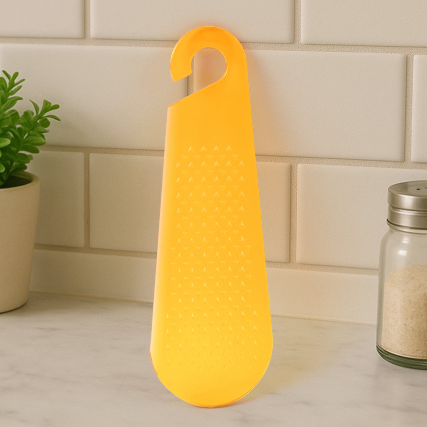 Wukusy multipurpose garlic and ginger grater and peeler tool with hanging hook for kitchen use, shown on a countertop.