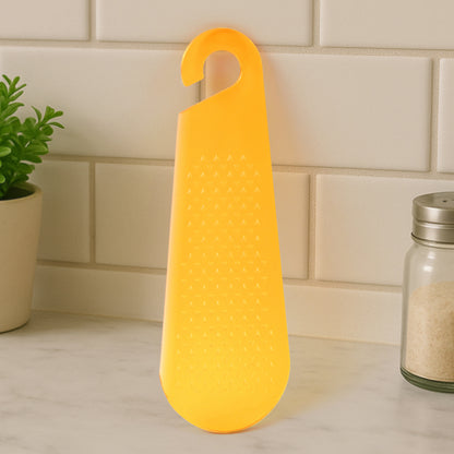 Wukusy multipurpose garlic and ginger grater and peeler tool with hanging hook for kitchen use, shown on a countertop.