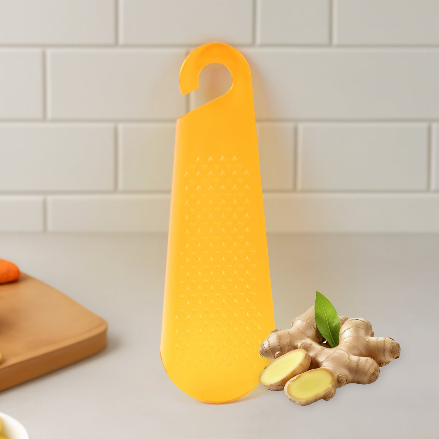 Wukusy multipurpose garlic and ginger grater and peeler tool with hanging hook in a kitchen setting.