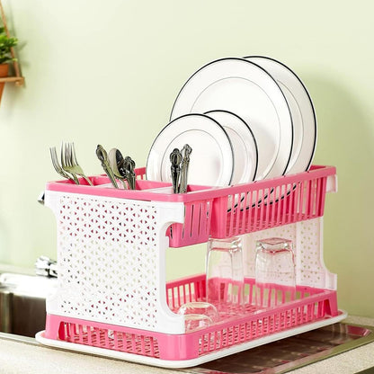 Wukusy plastic kitchen organizer rack with water storing tray holding utensils and kitchen tools on a countertop.