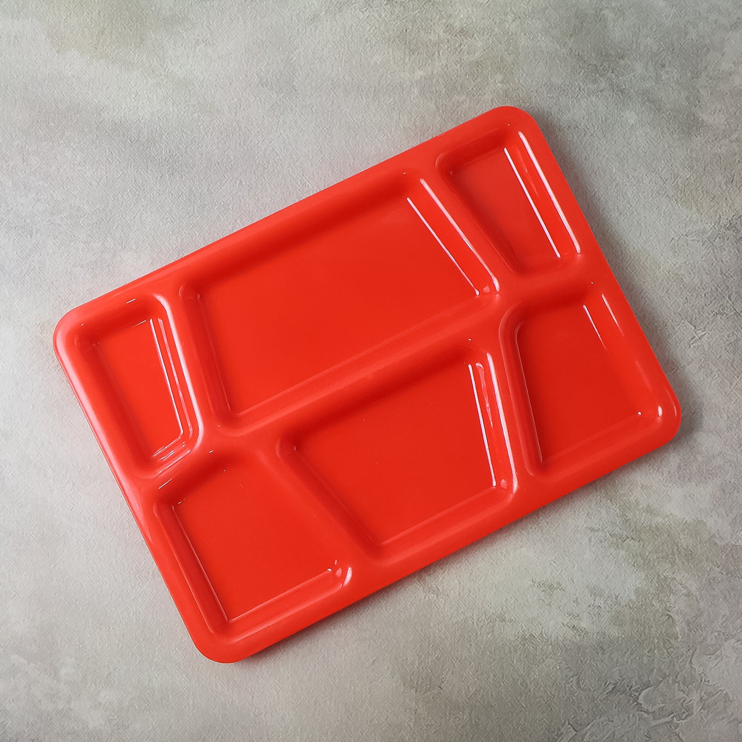 Red plastic multi-compartment rectangular meal serving tray from Wukusy, ideal for home and kitchen use.