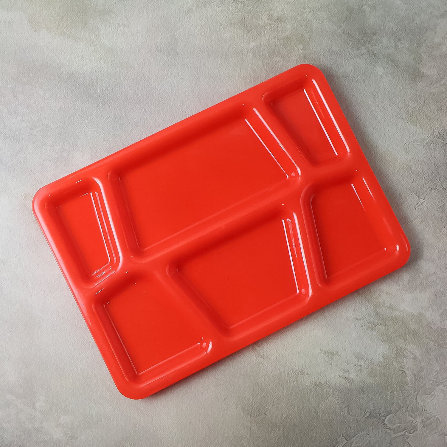 Red plastic multi-compartment rectangular meal serving tray from Wukusy, ideal for home and kitchen use.