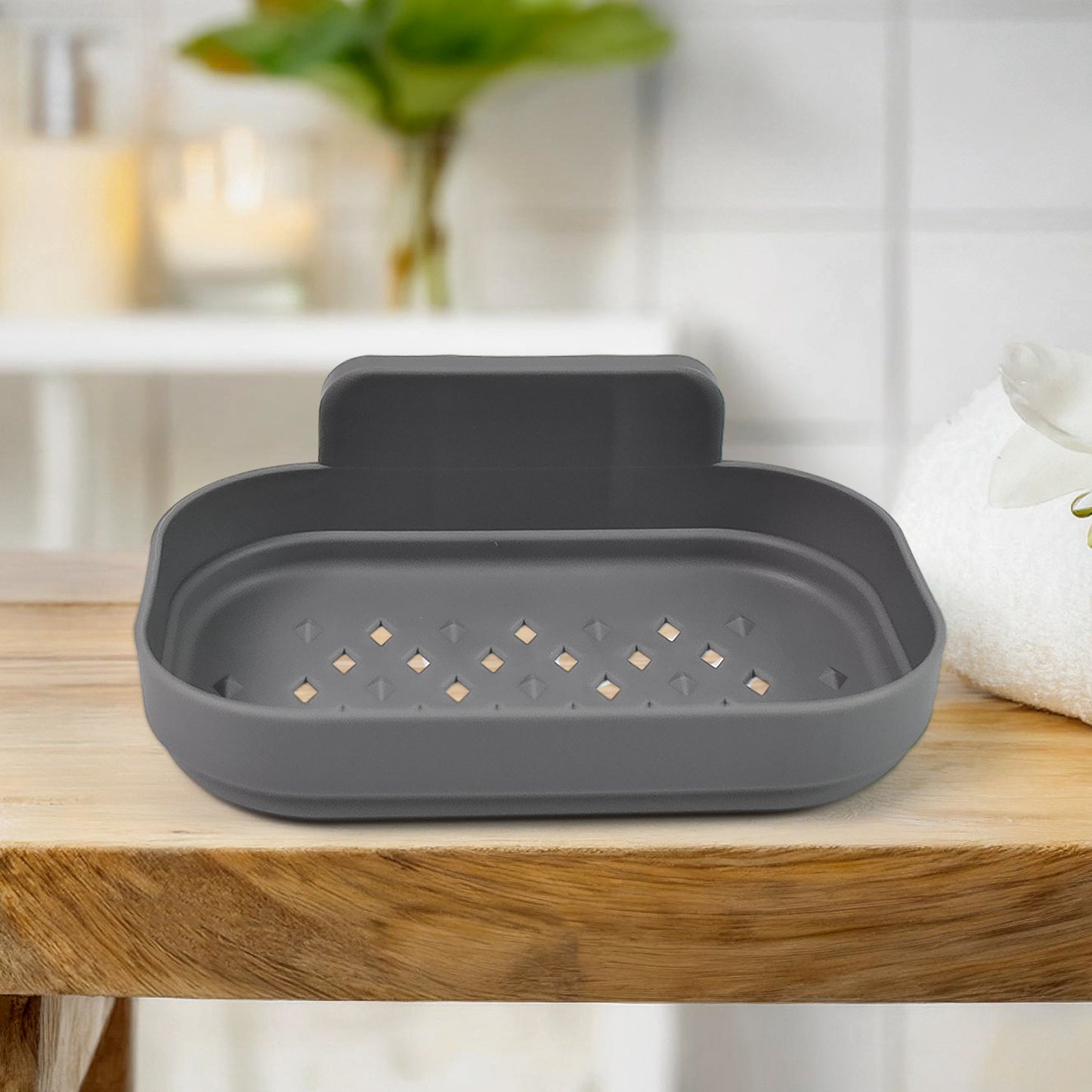 Wall-mounted plastic soap dish holder by Wukusy, self-adhesive bathroom shower accessory for organizing soap on the wall.