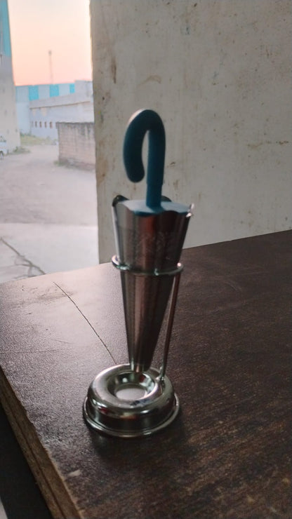 Wukusy reusable cute umbrella tea strainer with tray and stand, shown on a kitchen countertop for tea brewing.