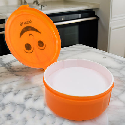 Wukusy Smily plastic lunch box with 2-in-1 spoon, small compact storage container for home and kitchen use.