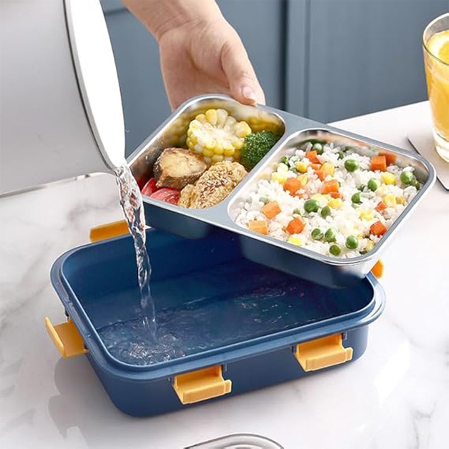 Stainless steel Wukusy lunch box with two compartments and a spoon, ideal for home and kitchen use.