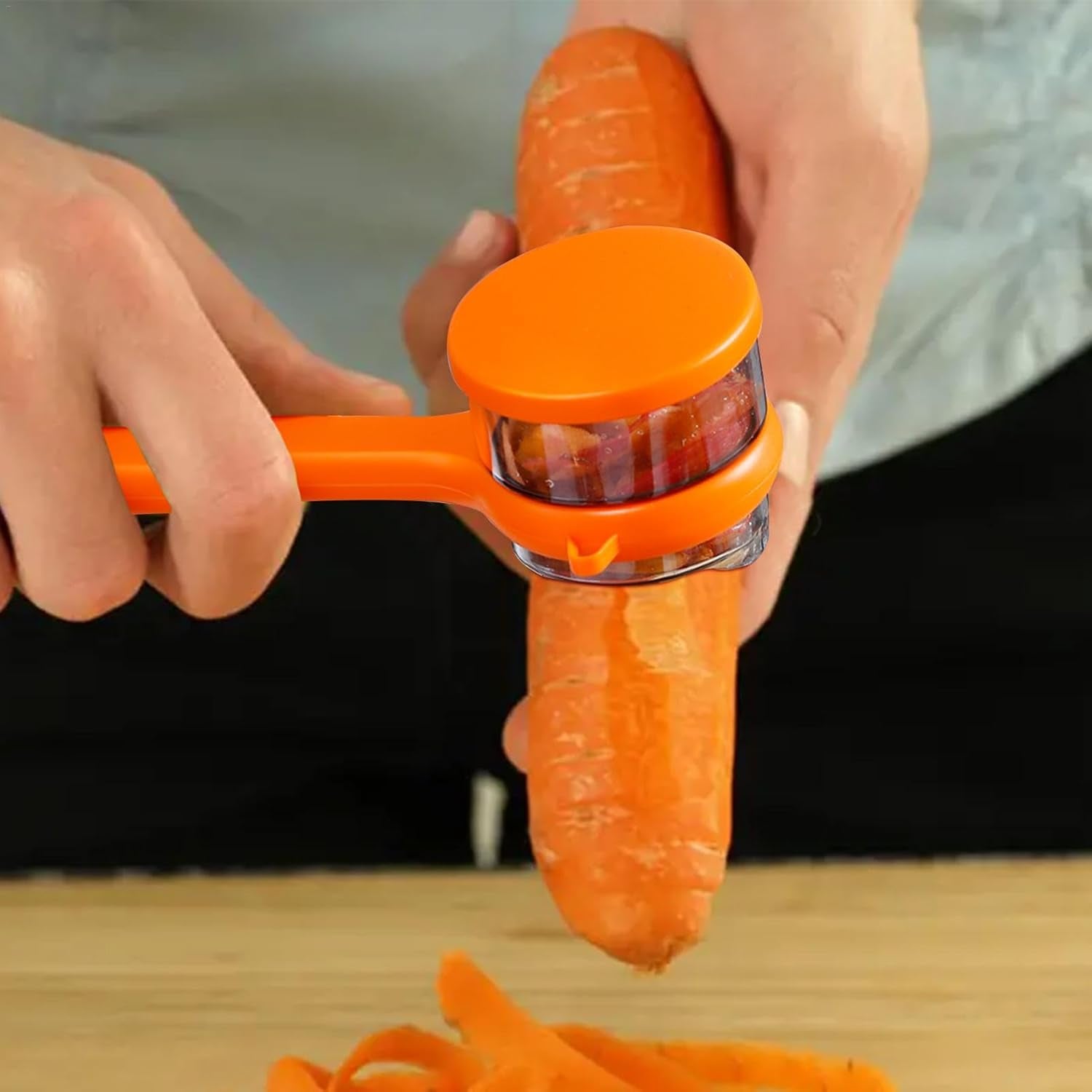 Wukusy stainless steel peeler with attached container for peeling and collecting produce, ideal for home and kitchen use.