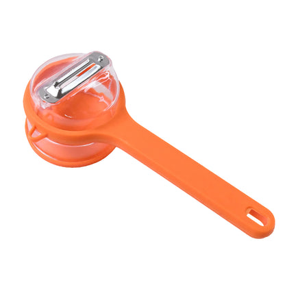 Wukusy stainless steel vegetable peeler with attached container for easy peeling and storage in a home kitchen setting.