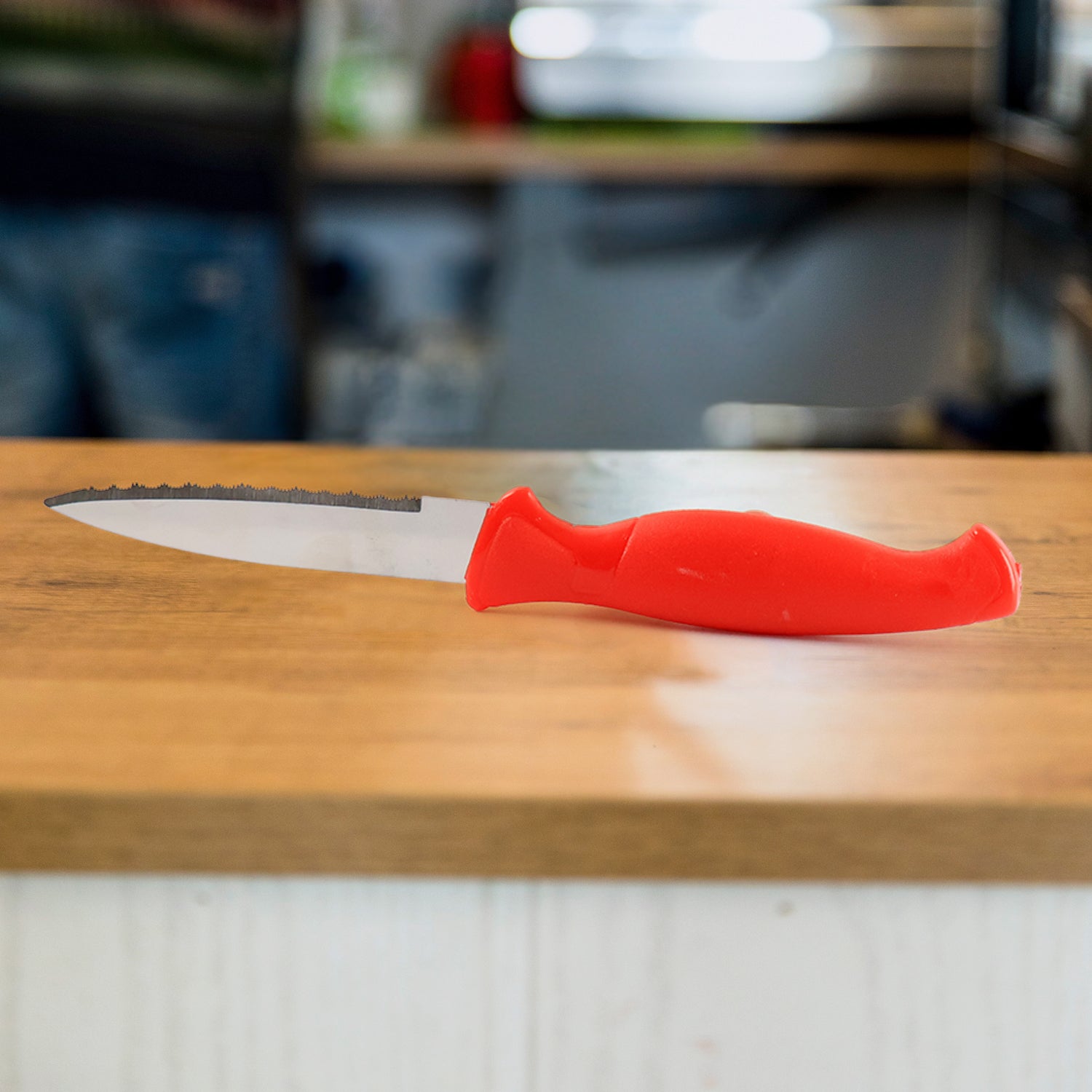 Wukusy stainless steel serrated kitchen knife with textured handle for precise slicing in home and kitchen use.