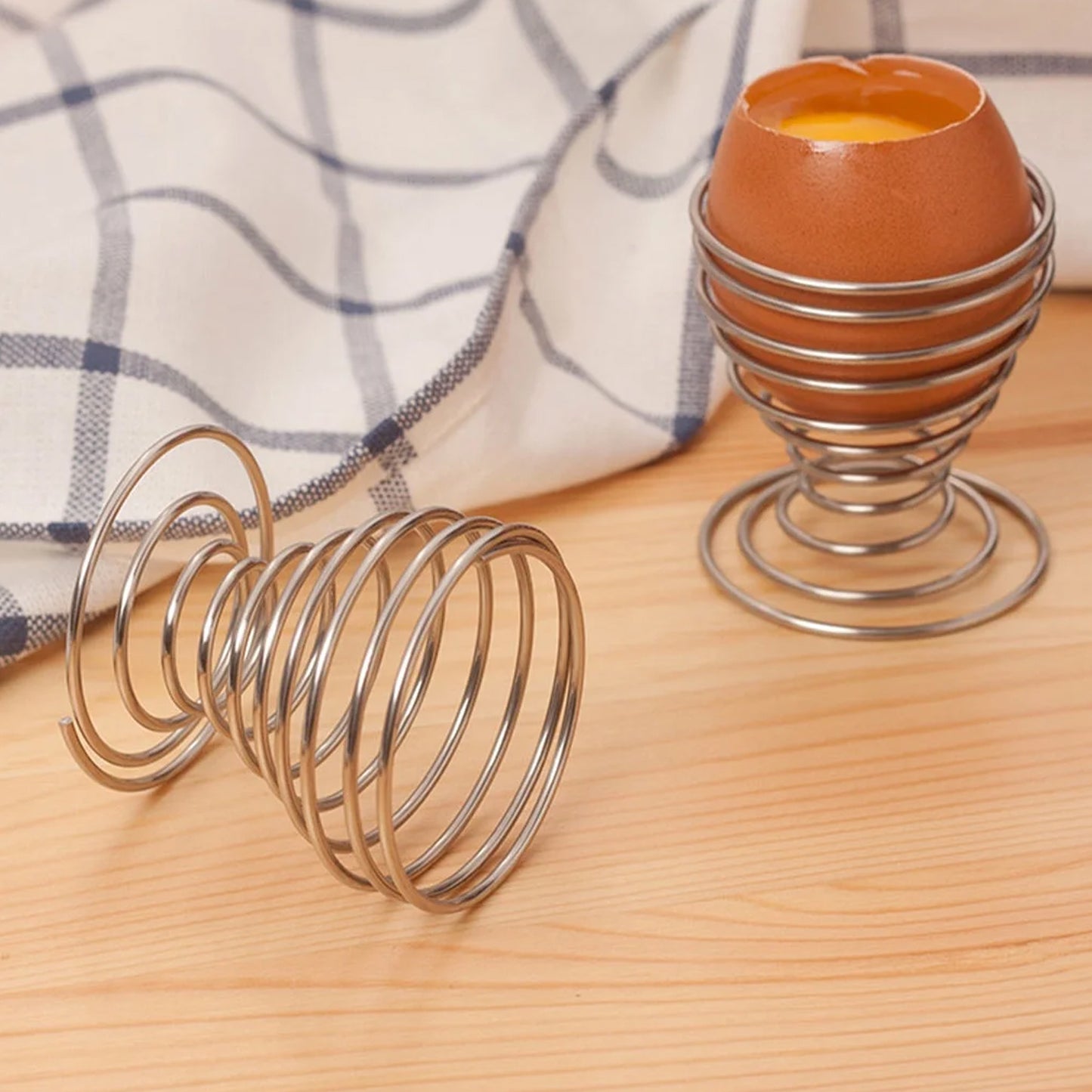 Stainless steel spring egg cup holder by Wukusy, designed for holding soft-boiled eggs in home and kitchen use.