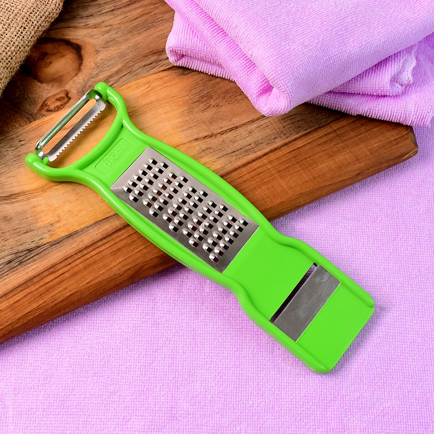 Wukusy Supermom 3-in-1 stainless steel vegetable and fruit peeler, multi-functional kitchen tool with ergonomic handle.