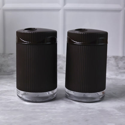 Wukusy Supermom Linoo salt and pepper dispenser set, 2-piece kitchen condiment shakers with clear glass and black caps.