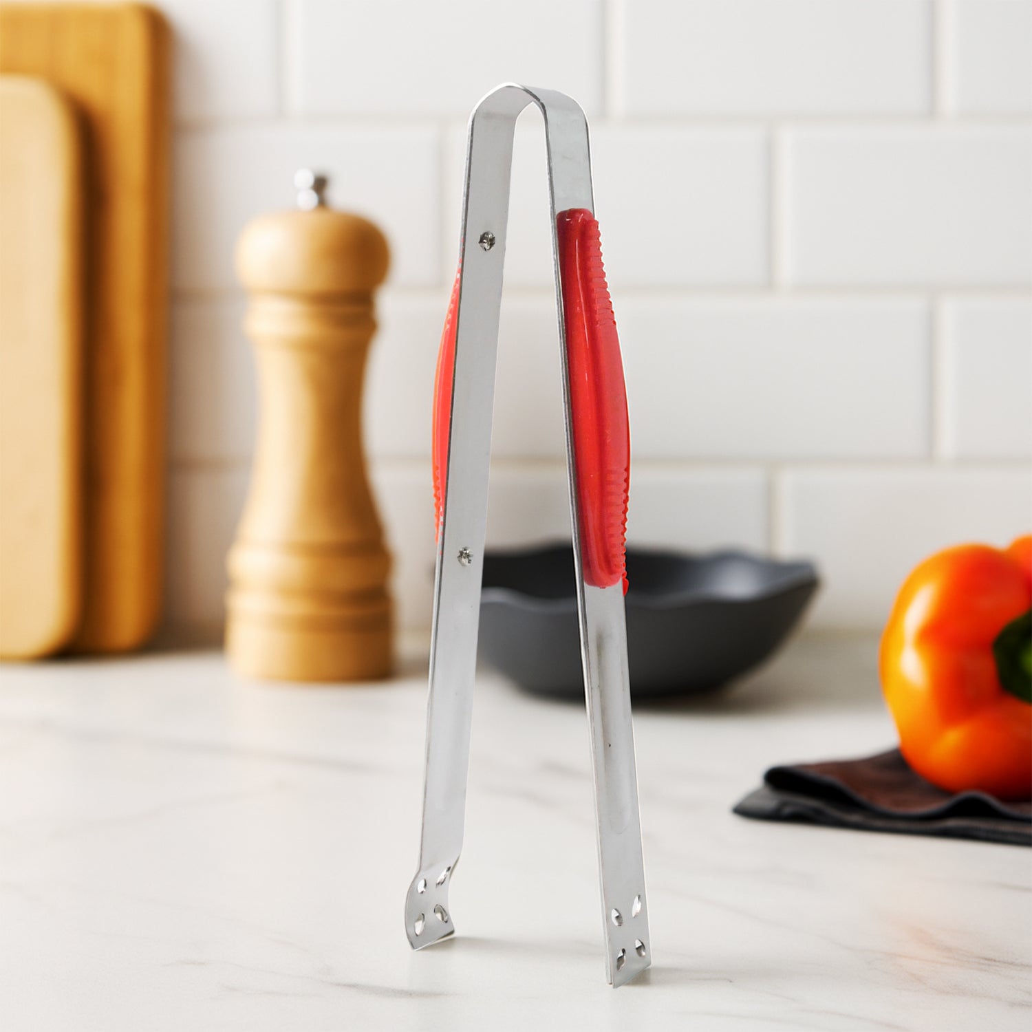 Wukusy Supermom premium stainless steel multipurpose kitchen tongs for cooking, grilling, and serving in a home kitchen setting.