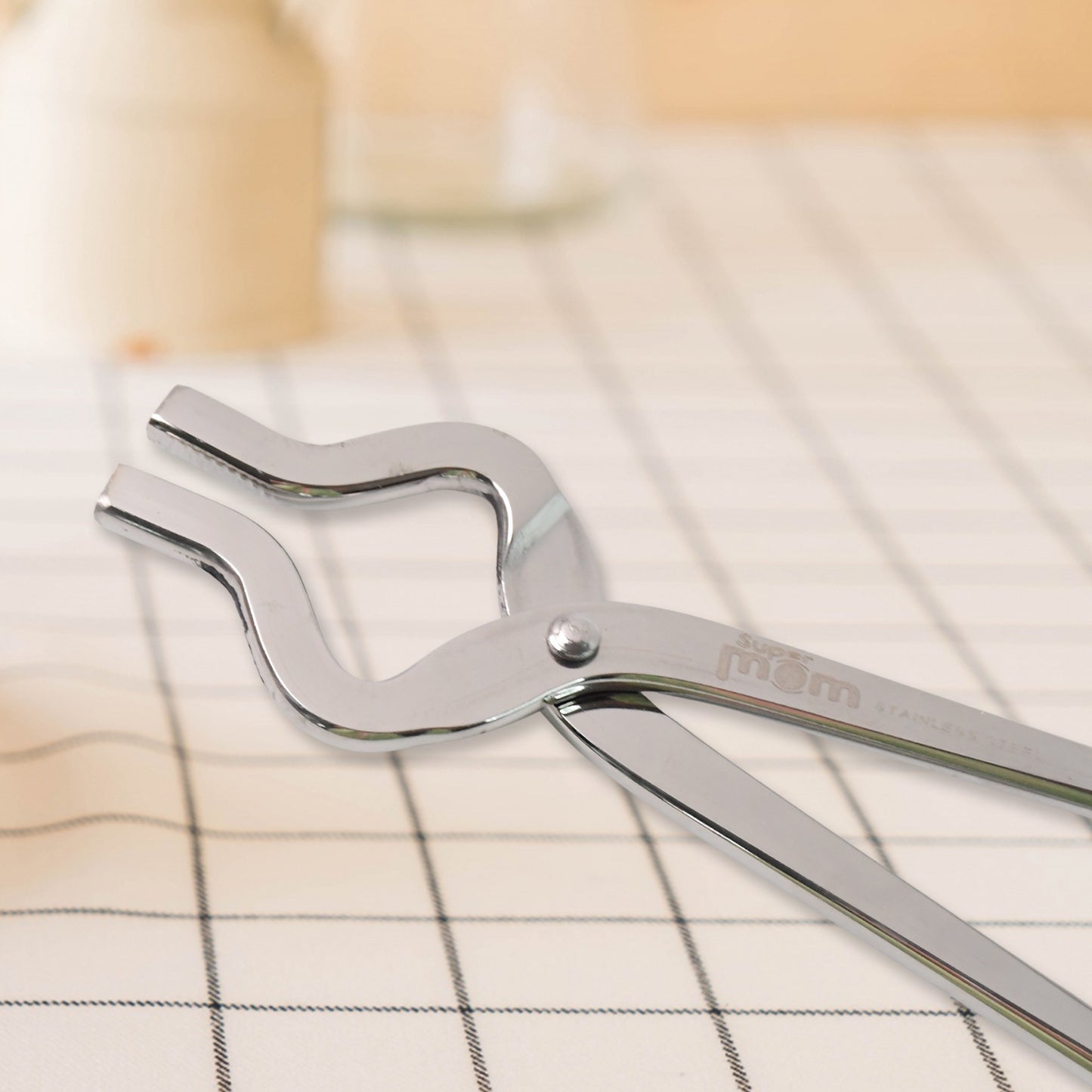 Wukusy Supermom stainless steel full round pincer for home and kitchen use, with a shiny curved metal design.