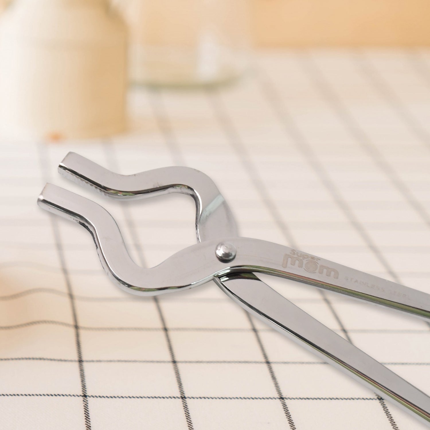 Wukusy Supermom stainless steel full round pincer for home and kitchen use, with a shiny curved metal design.