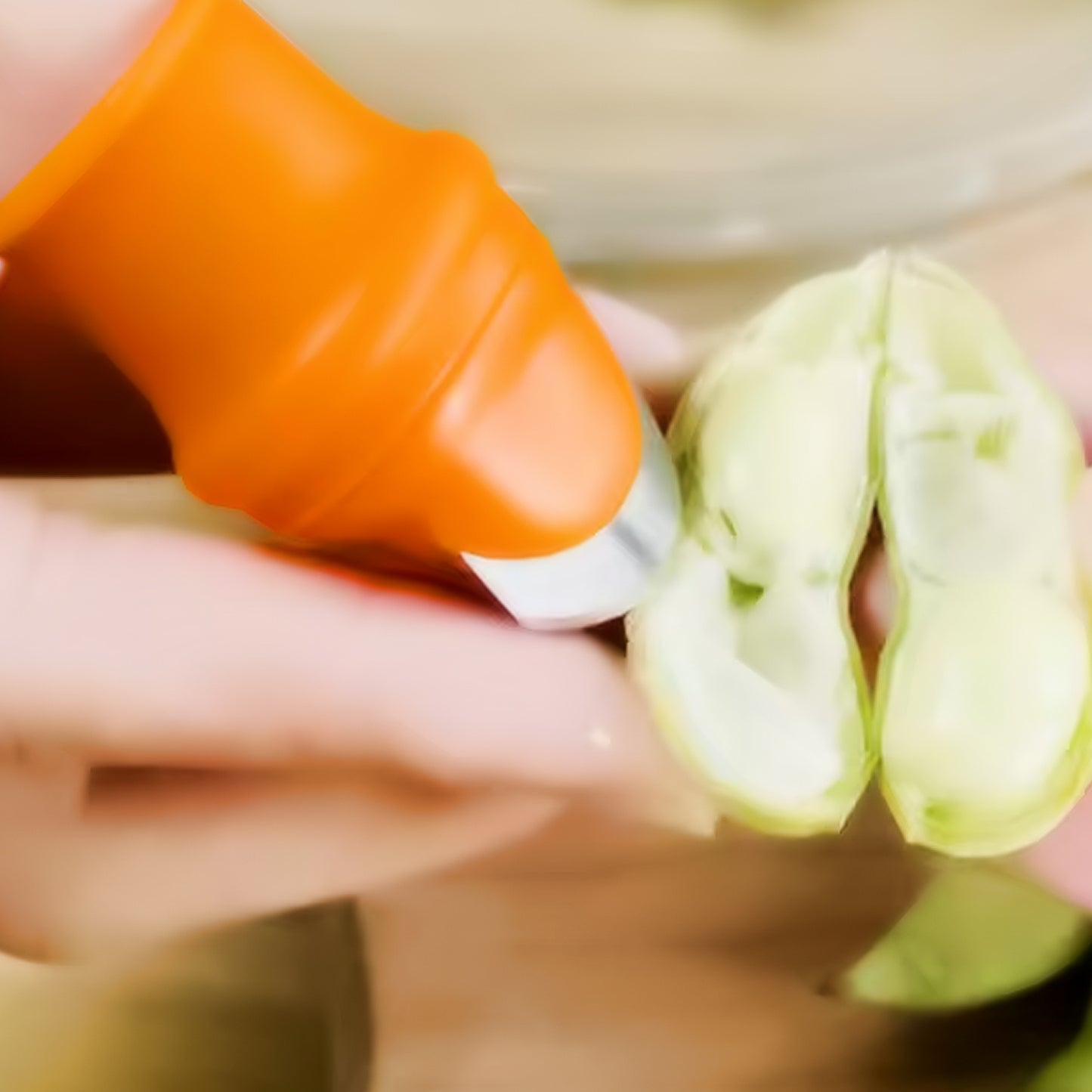 Wukusy thumb knife cutter with silicone finger guard for safe, precise slicing in home and kitchen food preparation.