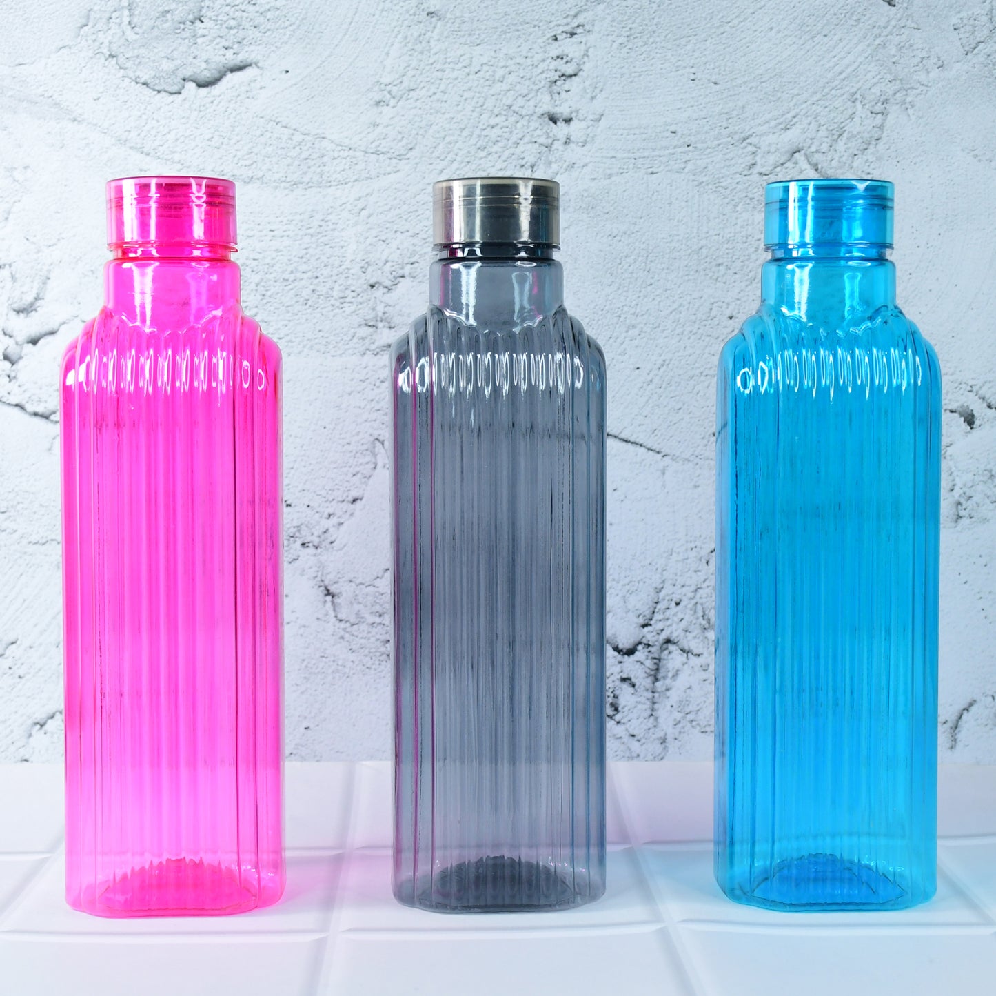 Set of three transparent Wukusy fridge water bottles for home use, showcasing clear design and secure caps.