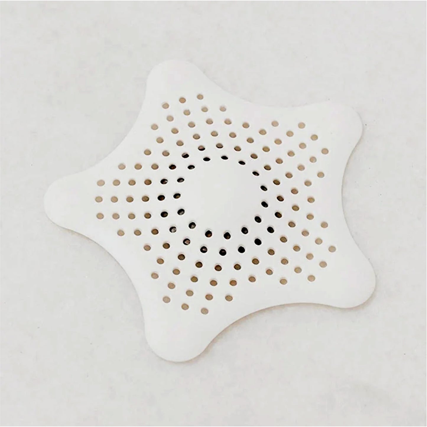 White silicone star-shaped sink filter by Wukusy, bathroom hair catcher and drain strainer for basin, prevents clogs and debris.