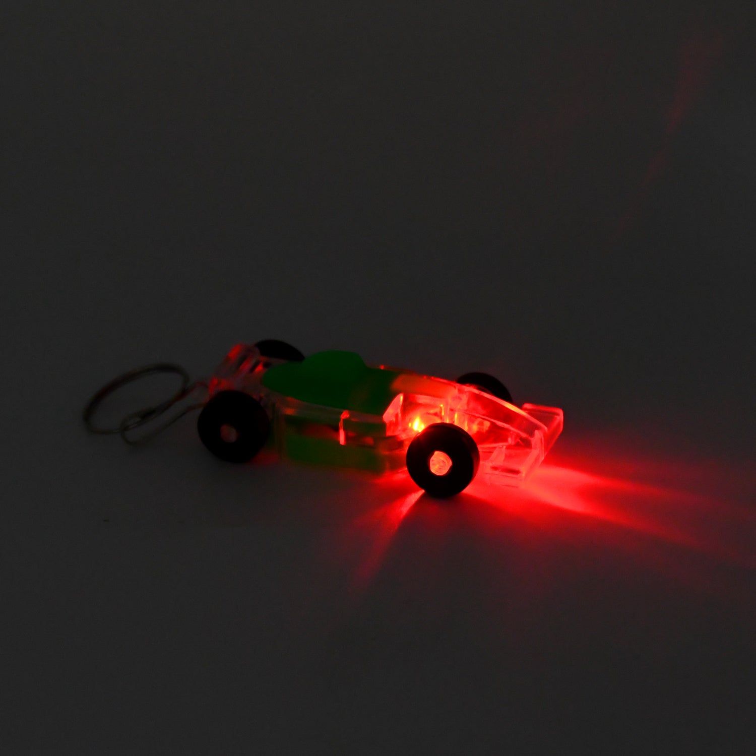 Kids' cars-shaped keychain with on/off button and LED flashing light by Wukusy, featuring colorful car design and light feature.