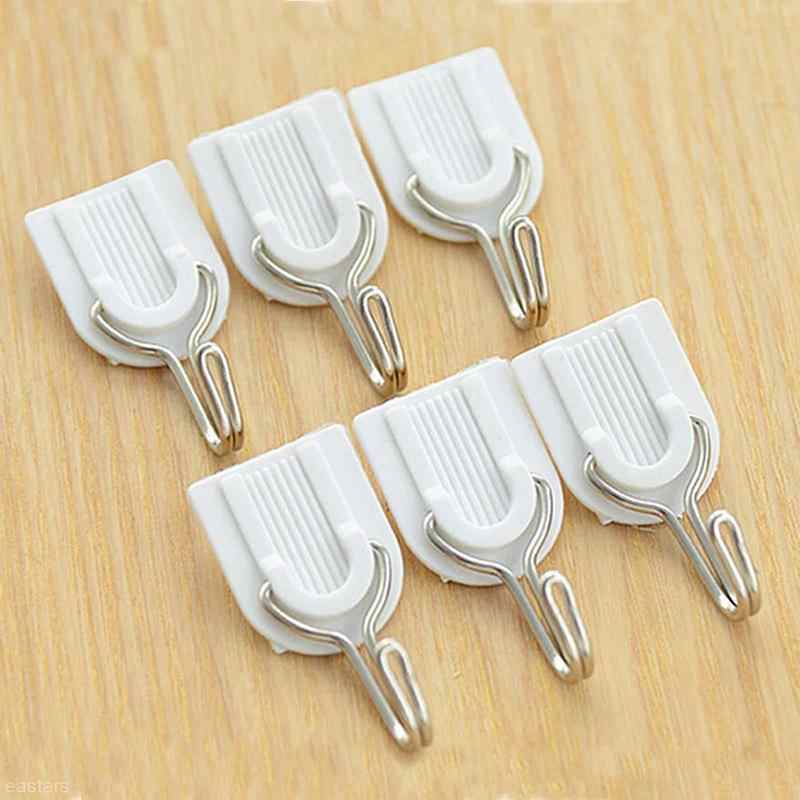 Wukusy adhesive ABS plastic hook towel hanger for kitchen and bathroom, mounted on a wall for hanging towels and kitchen tools.