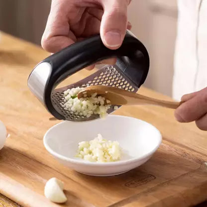 Wukusy stainless steel garlic presser and ginger crusher, versatile kitchen tool for quick garlic and ginger squeezing.