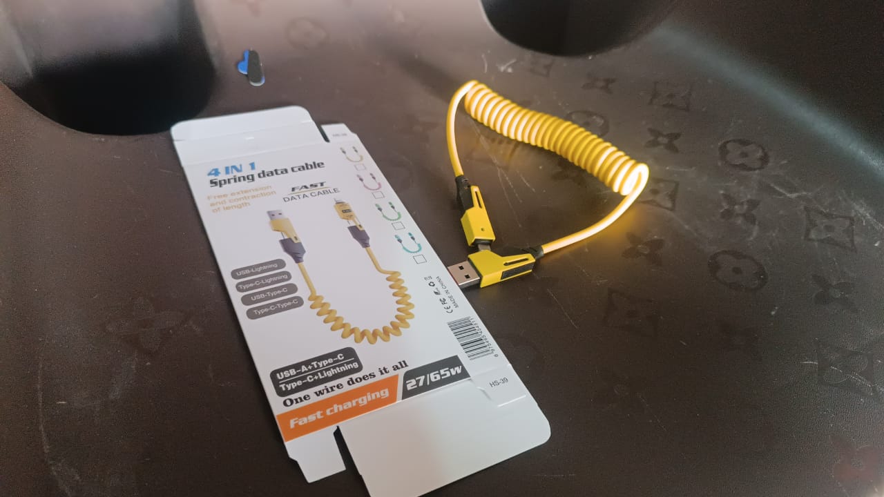 Wukusy 4-in-1 spring fast charging cable for mobile devices, 1.5 meters long, with multiple connector options for convenience.