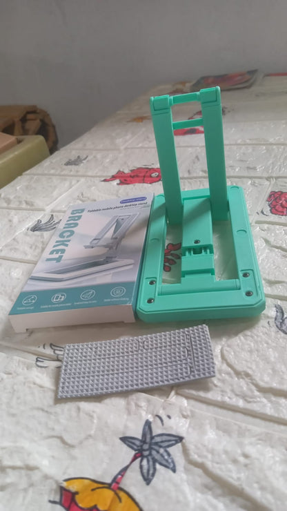 Wukusy mobile phone stand and holder with adjustable angle, foldable design, non-slip base, suitable for all smartphones on a desk.